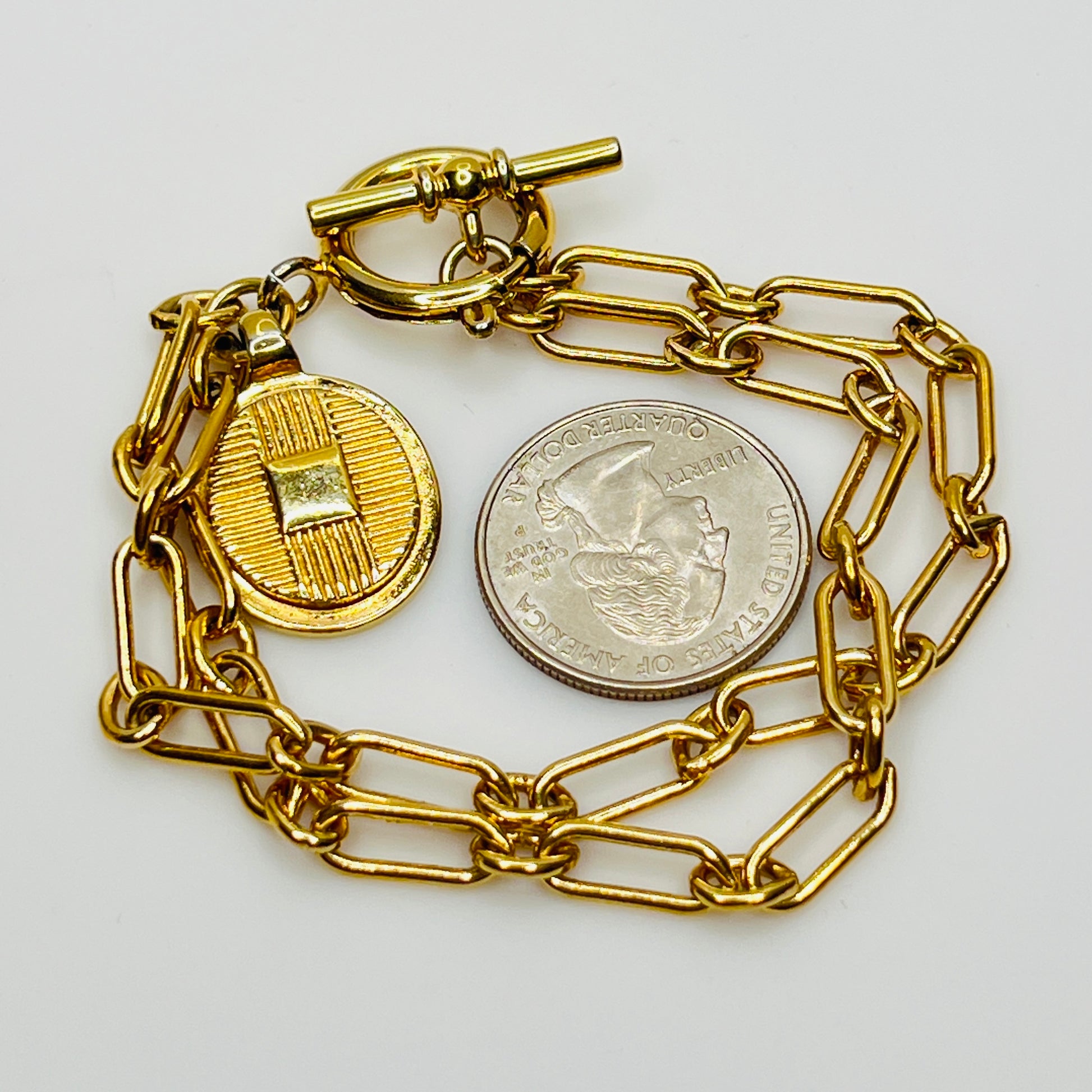 Close-up of round basketweave charm on vintage Ralph Lauren bracelet