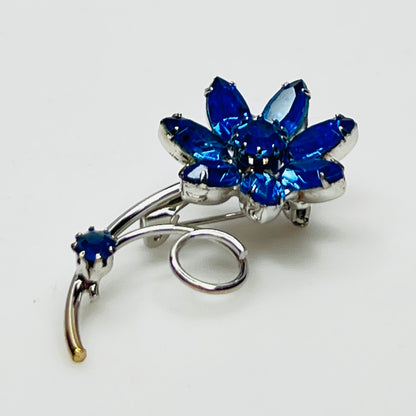 Angled view of brooch showing depth and sparkle of prong-set stones