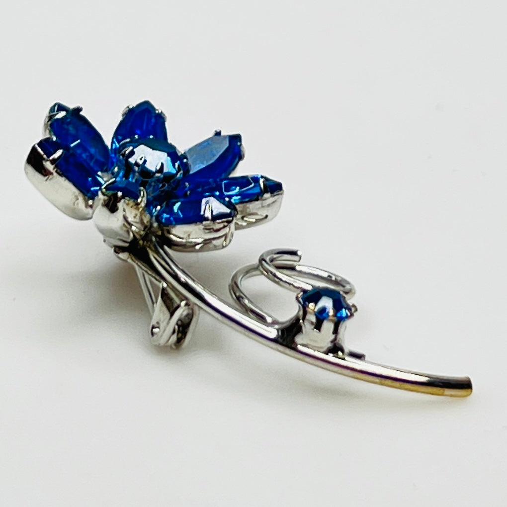 Angled view of brooch showing depth and sparkle of prong-set stones