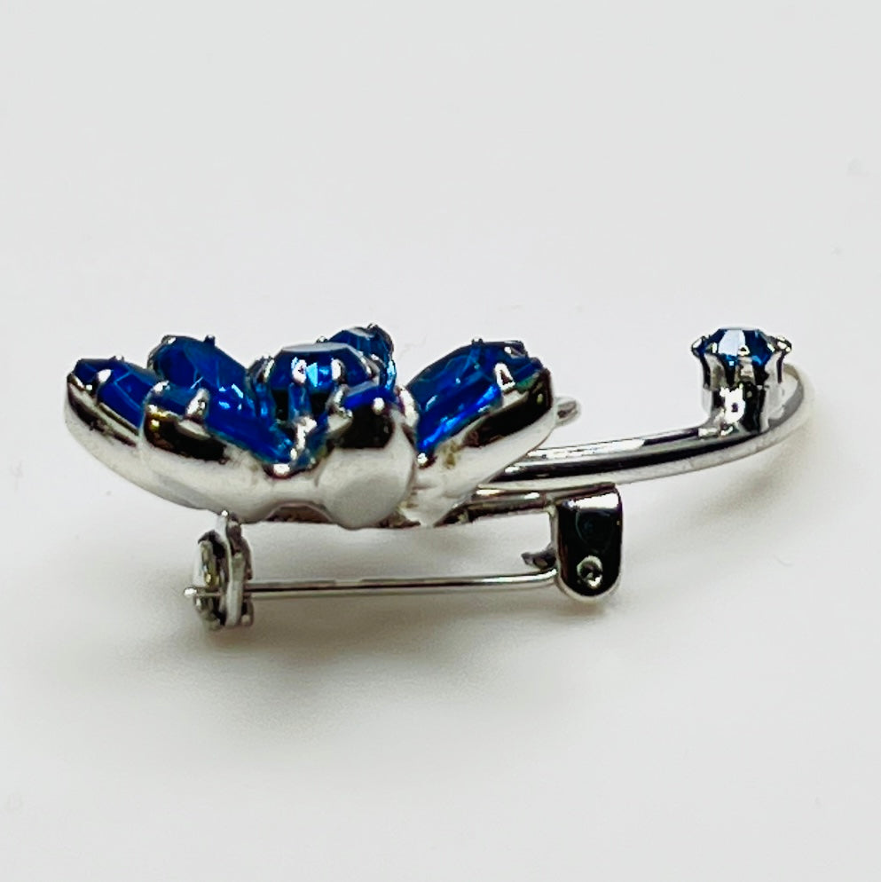 Angled view of brooch showing depth and sparkle of prong-set stones