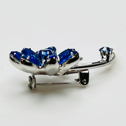 Angled view of brooch showing depth and sparkle of prong-set stones