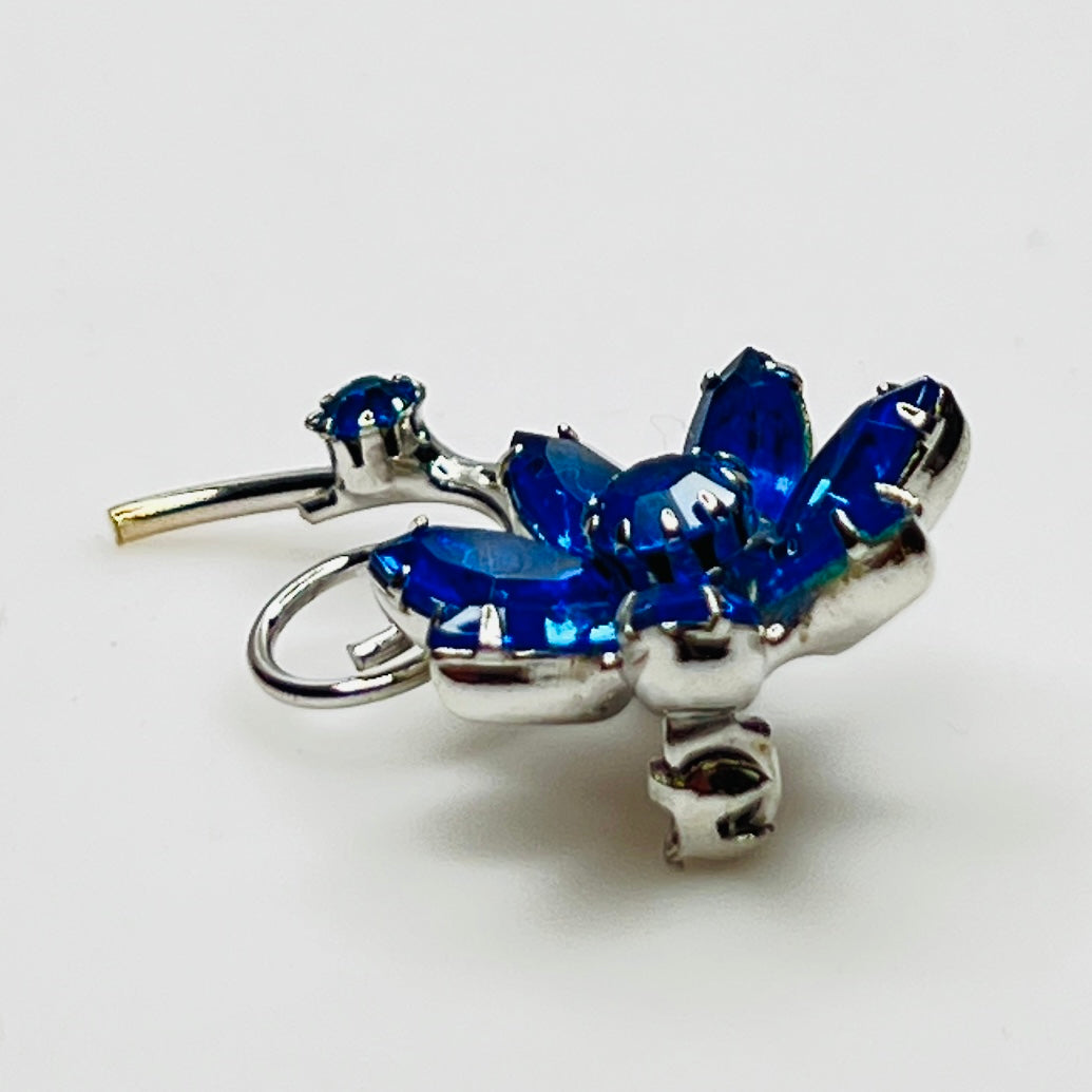 Angled view of brooch showing depth and sparkle of prong-set stones