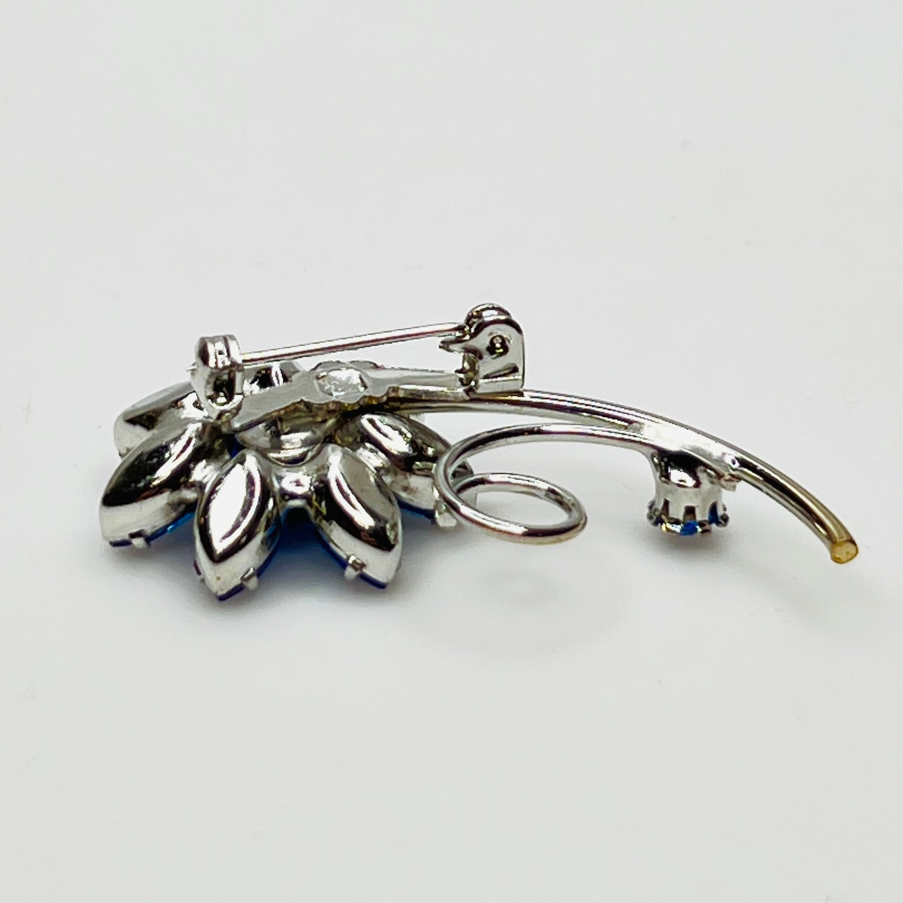 Reverse of brooch with polished silver-tone back and pin clasp