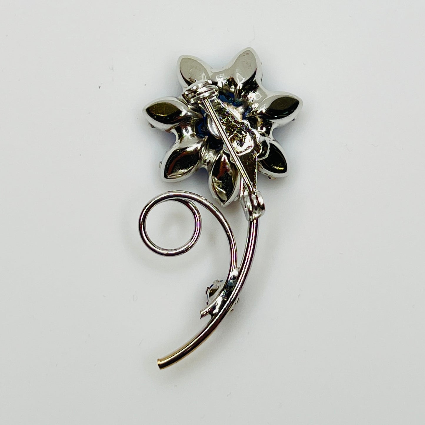 Reverse of brooch with polished silver-tone back and pin clasp