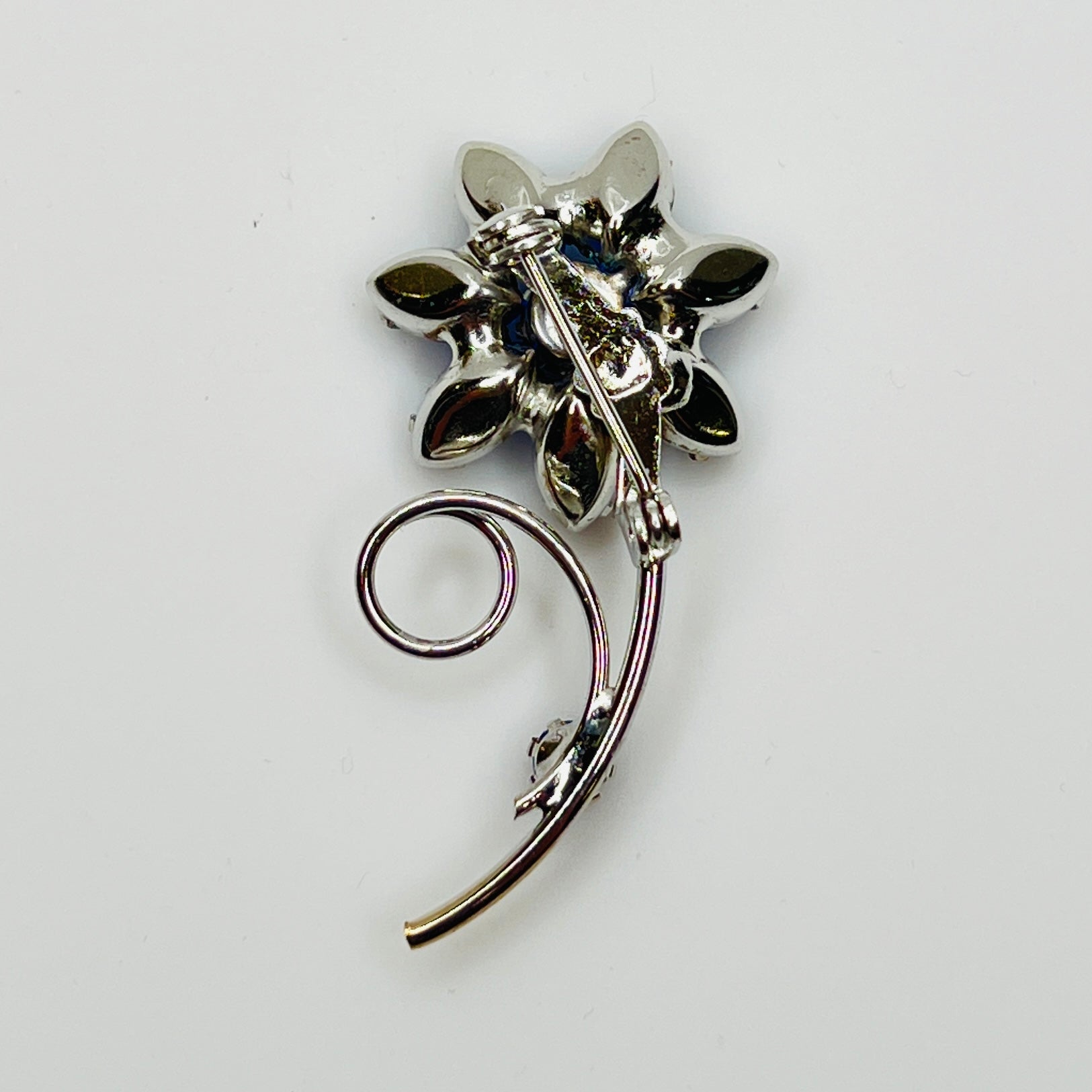 Reverse of brooch with polished silver-tone back and pin clasp