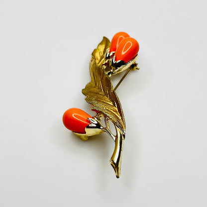 Angled side view of vintage brooch showing dimension and leaf texture