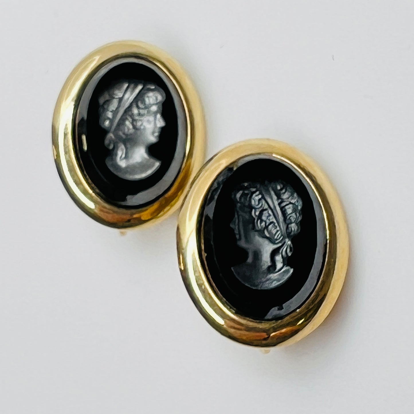 Sarah Coventry oval clip-on earrings with hematite intaglio profiles – front view