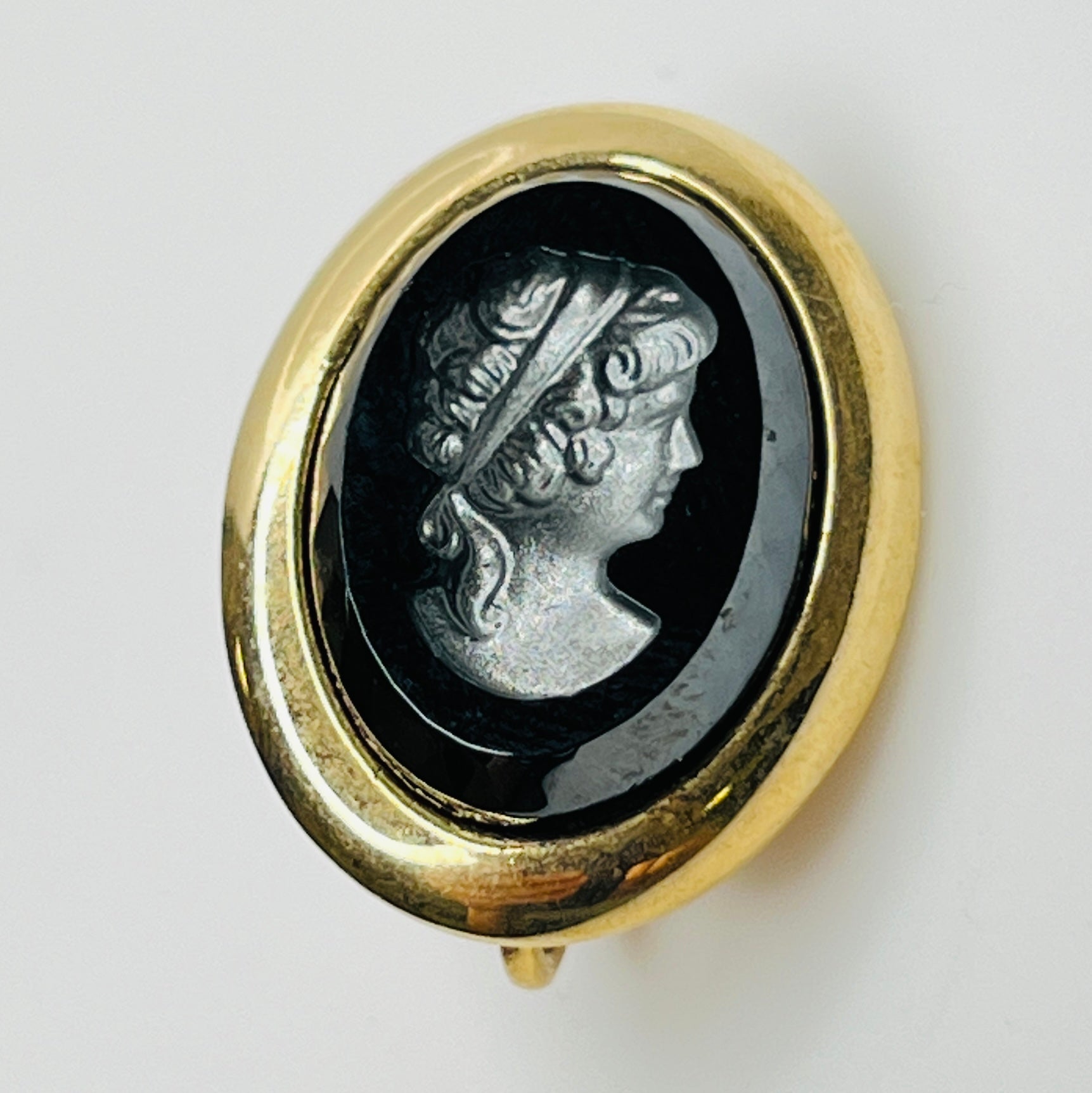 Sarah Coventry oval clip-on earrings with hematite intaglio profiles – front view