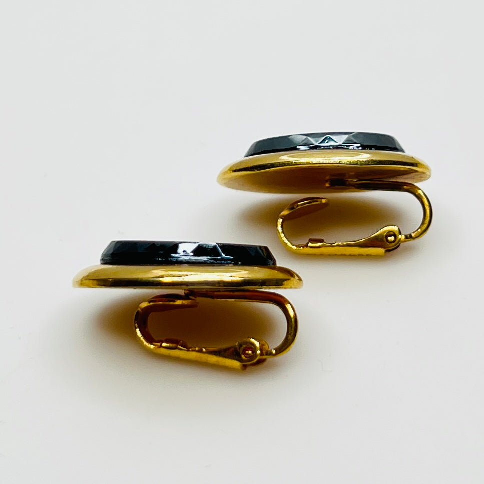 Side view of earrings showing raised gold-tone setting and secure clips