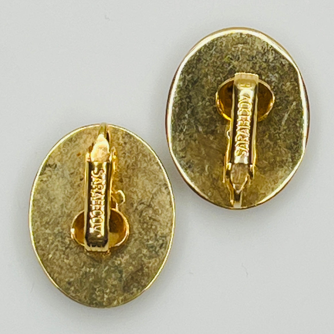 Reverse of earrings signed Sarah Coventry on clip backs