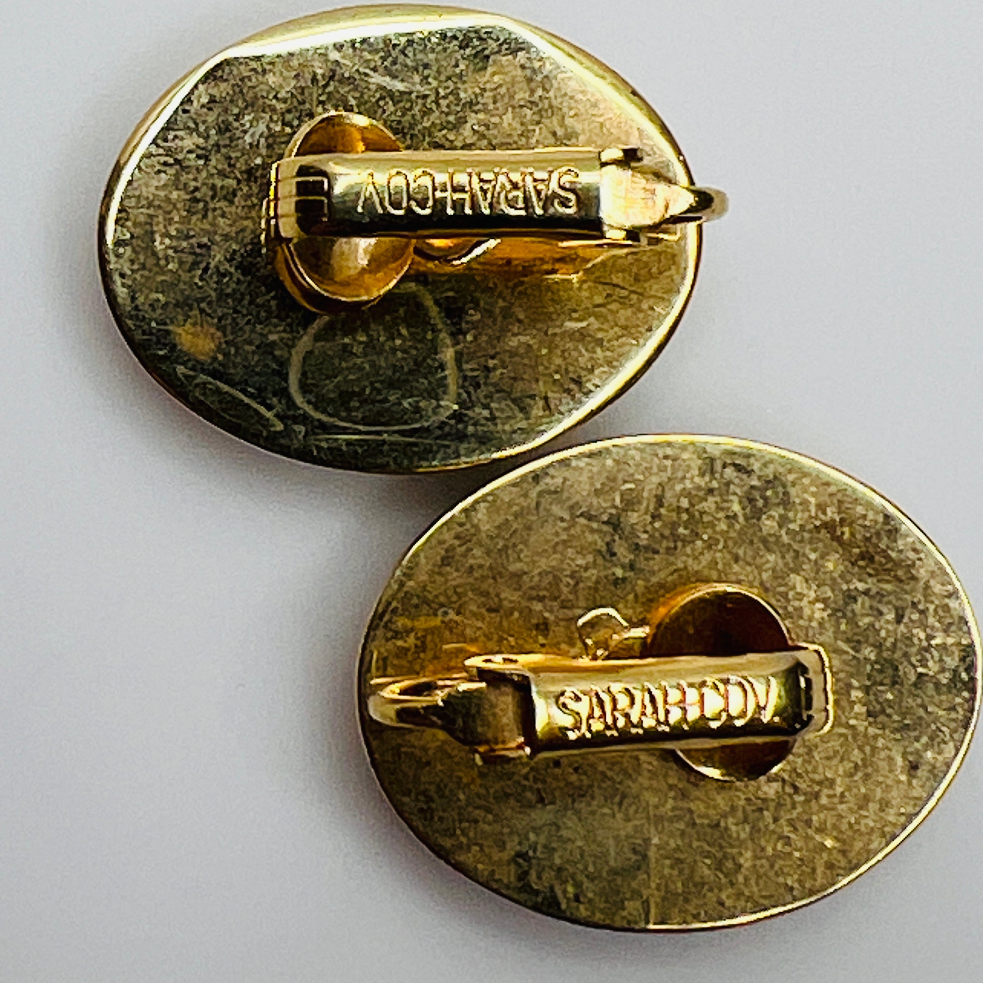Reverse of earrings signed Sarah Coventry on clip backs