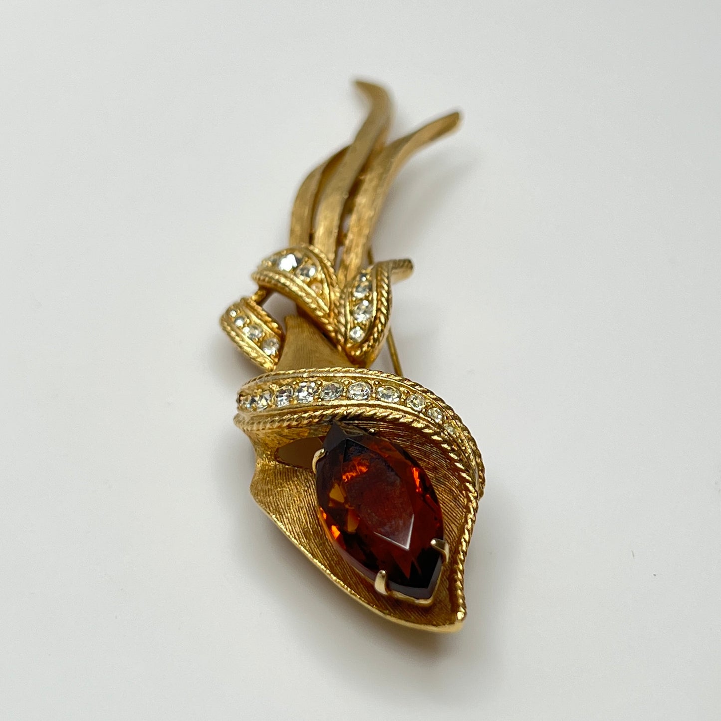 Gold-tone calla lily brooch with amber rhinestone and clear accents, signed Sarah Coventry