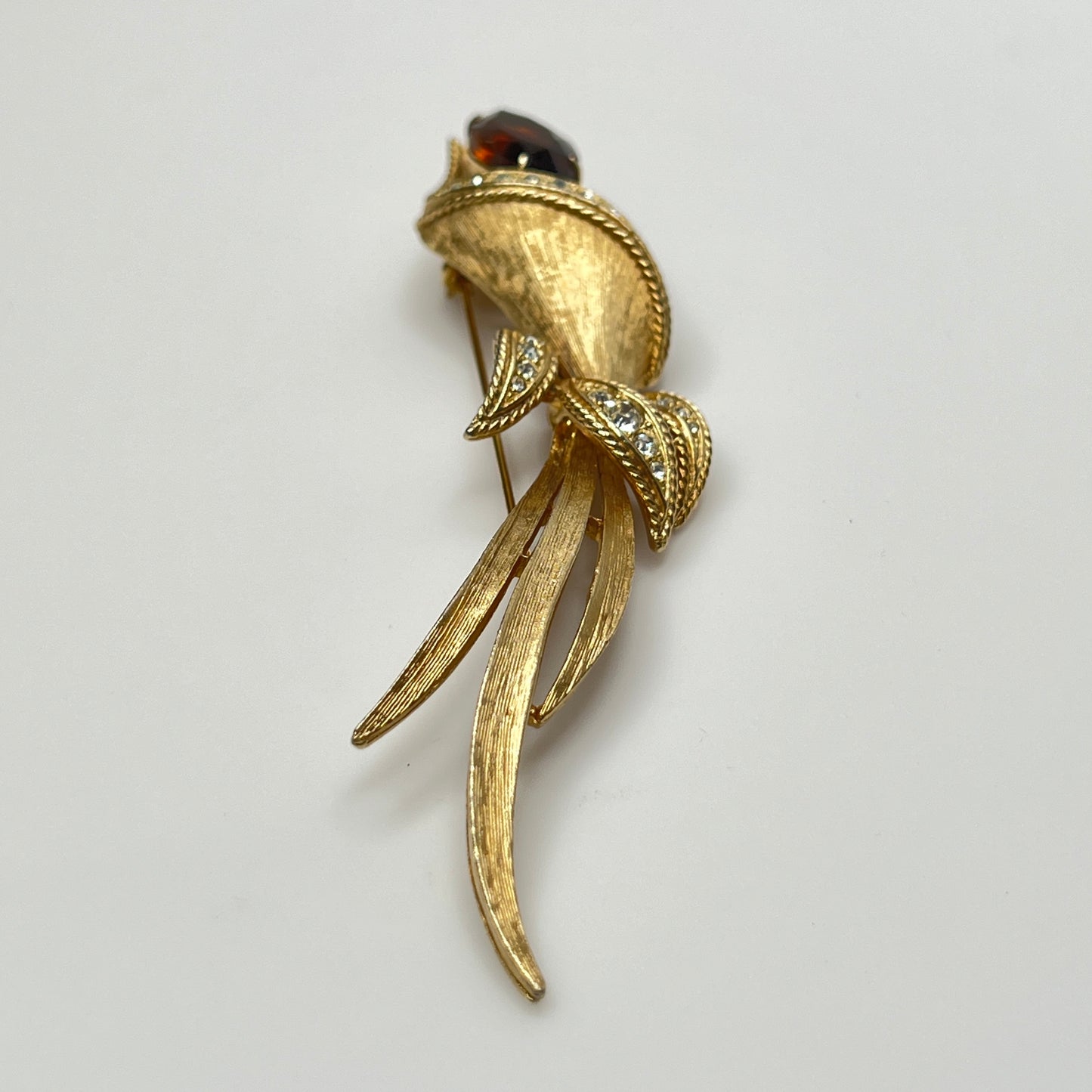 Gold-tone calla lily brooch with amber rhinestone and clear accents, signed Sarah Coventry