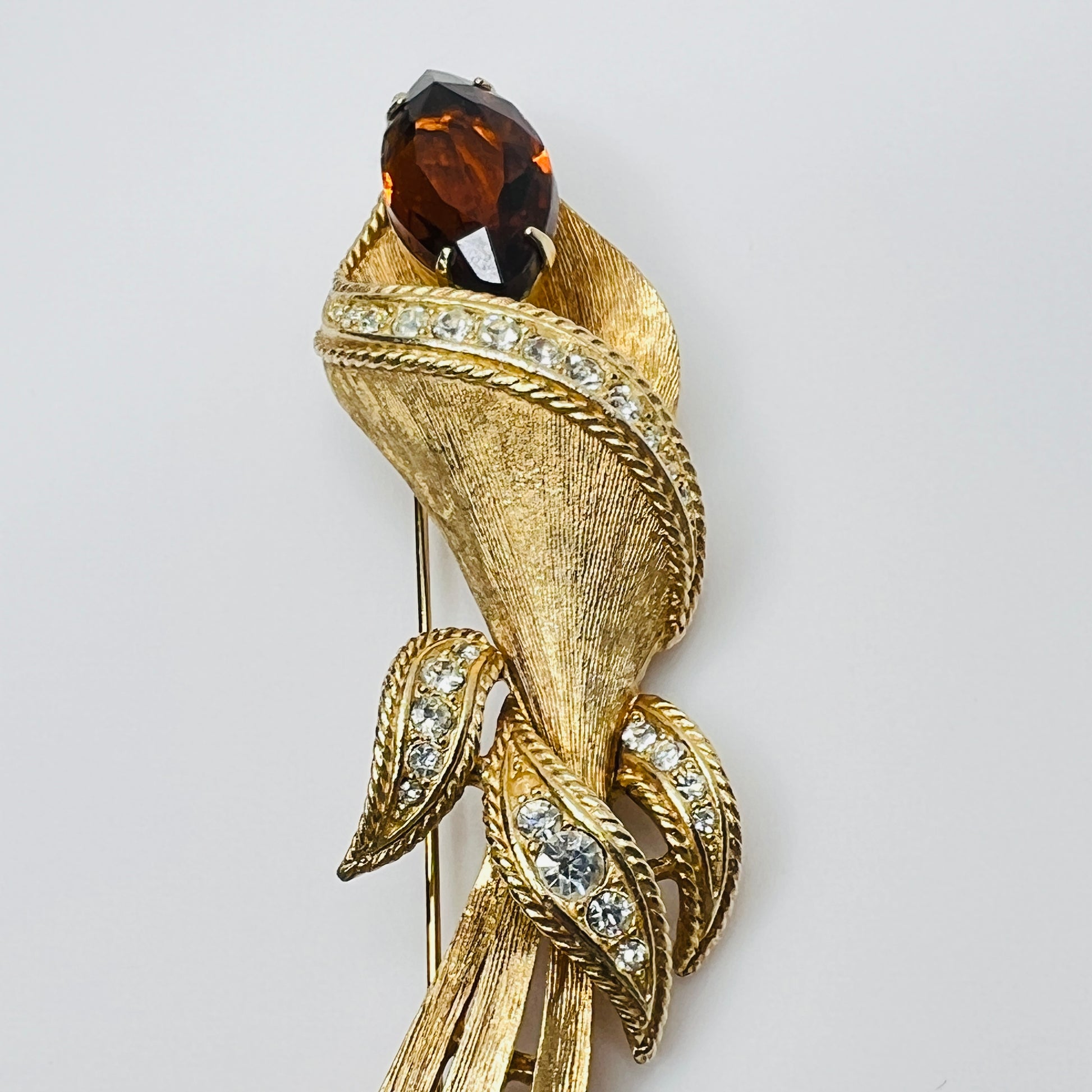Gold-tone calla lily brooch with amber rhinestone and clear accents, signed Sarah Coventry