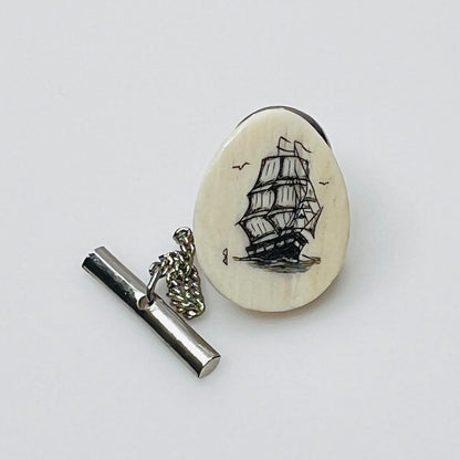 Vintage scrimshaw tie tack with sailing ship on ivory oval