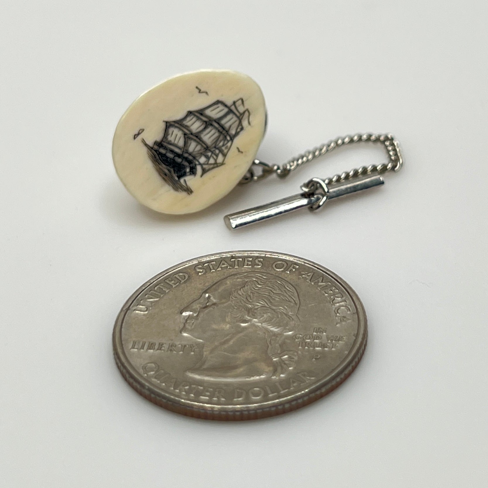Vintage scrimshaw tie tack with sailing ship on ivory oval