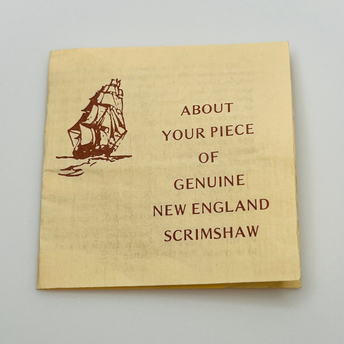 Beige card with ship illustration and text about New England scrimshaw on a light gray background