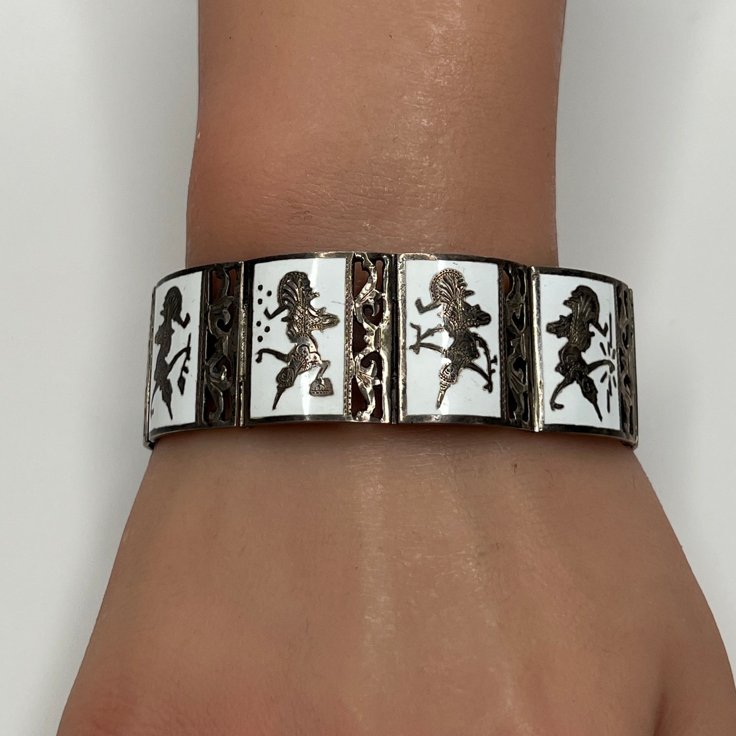 Siam Sterling bracelet on wrist, nine panel design with mythological figures