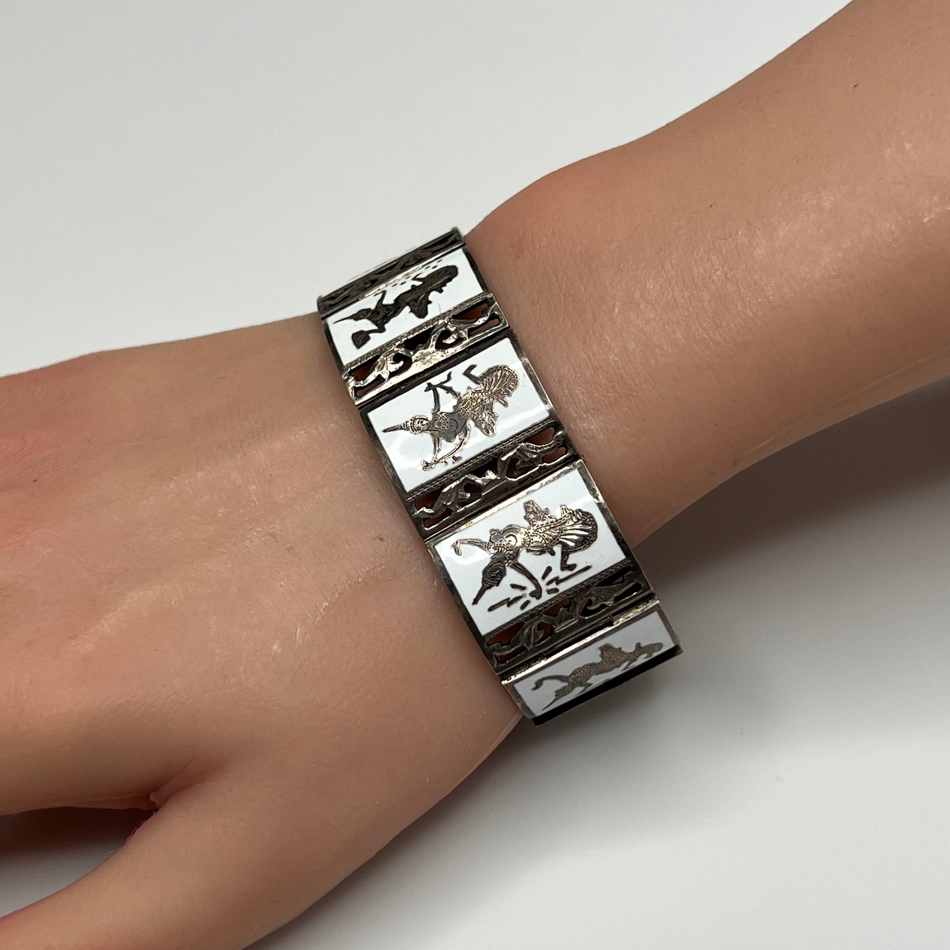 Siam Sterling bracelet on wrist, nine panel design with mythological figures