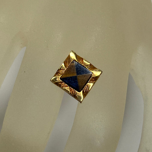 Close-up of Karatclad gold tie pin with navy and brown stone inlay