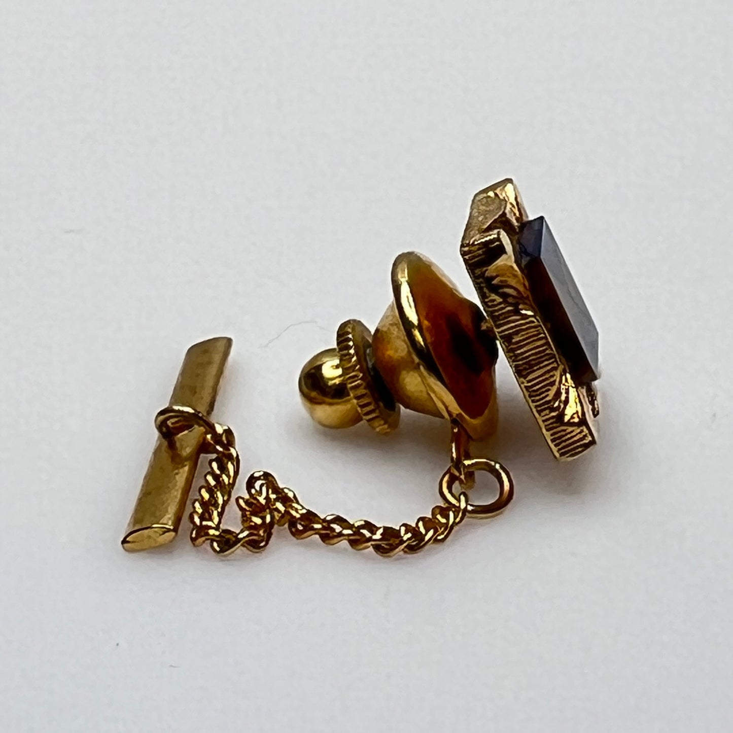 Simmons Karatclad tie tack with gold and gemstone square design