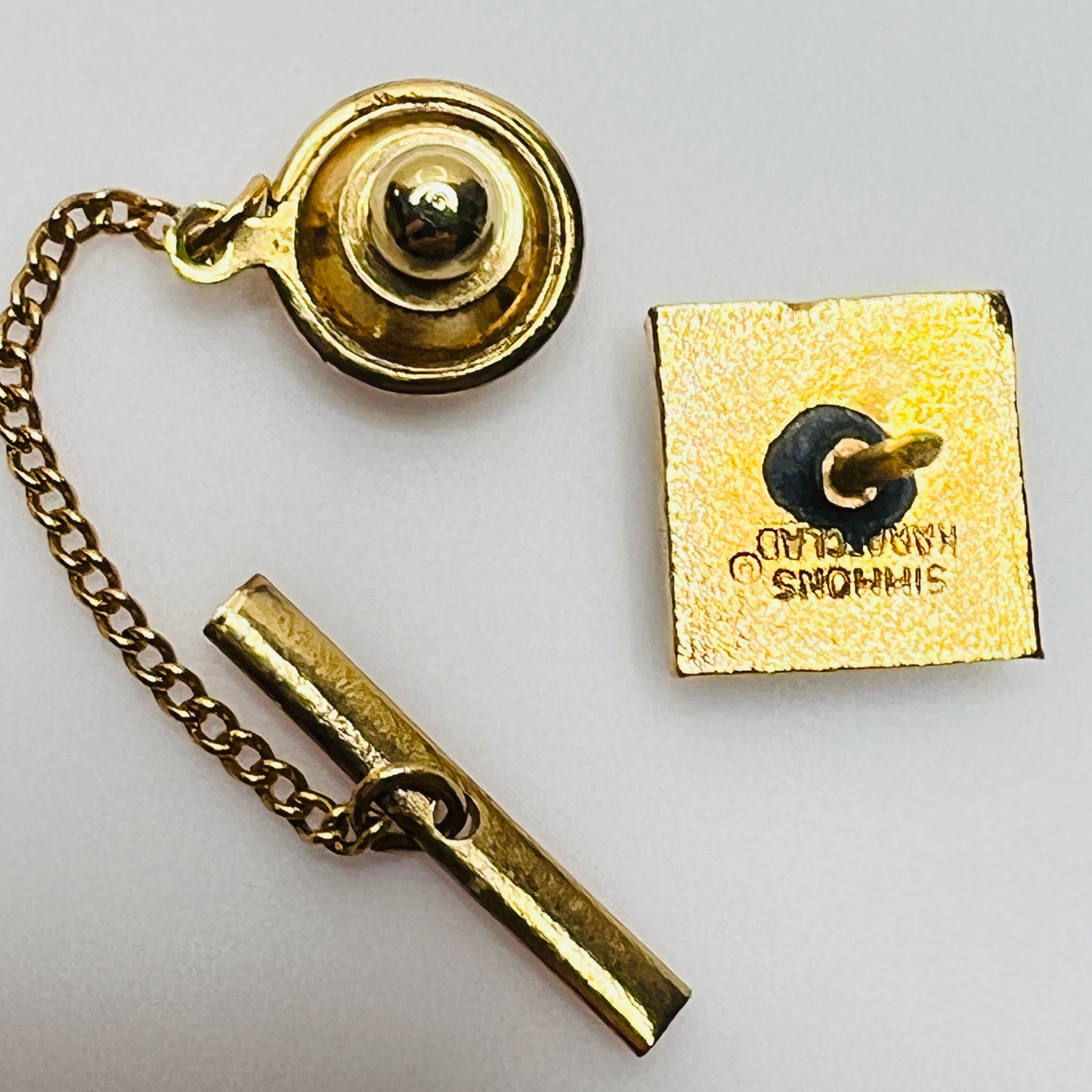 Vintage 1970s tie tack with geometric gemstone and etched gold border