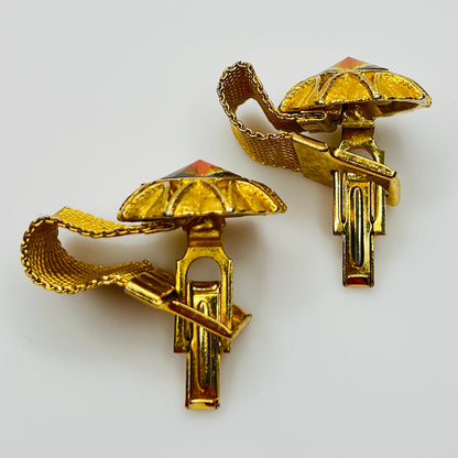 Close-up of round prismatic rivoli cufflink in gold-tone sunburst bezel