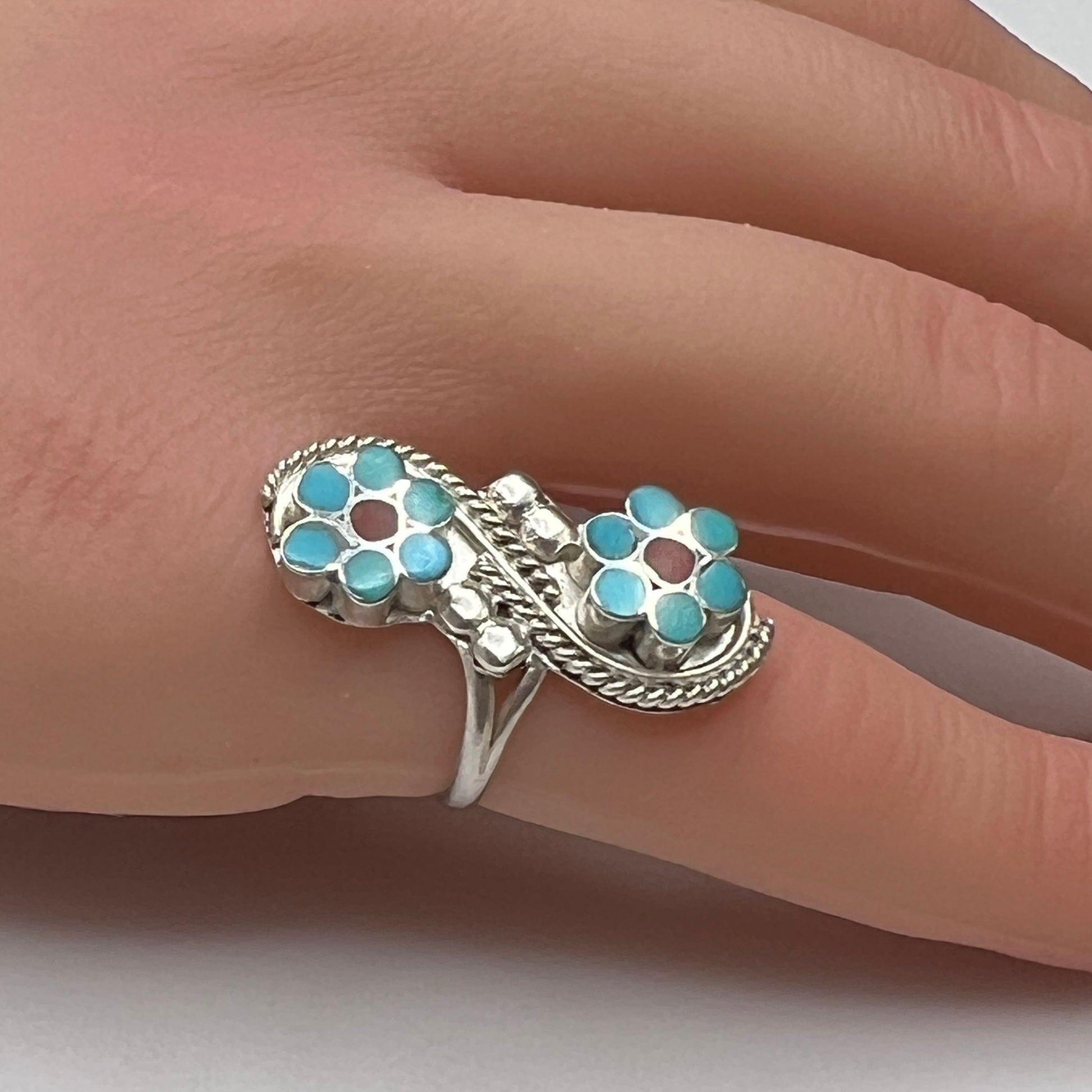 Sterling silver turquoise flower ring on hand, pinky fit with double floral design