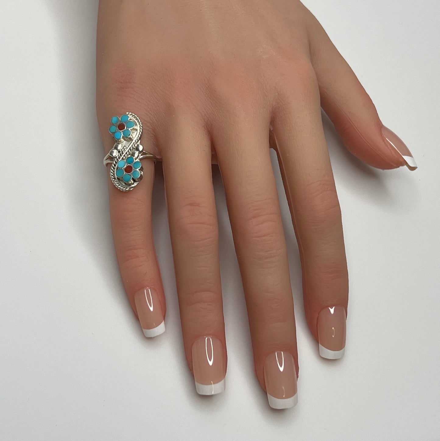 Sterling silver turquoise flower ring on hand, pinky fit with double floral design