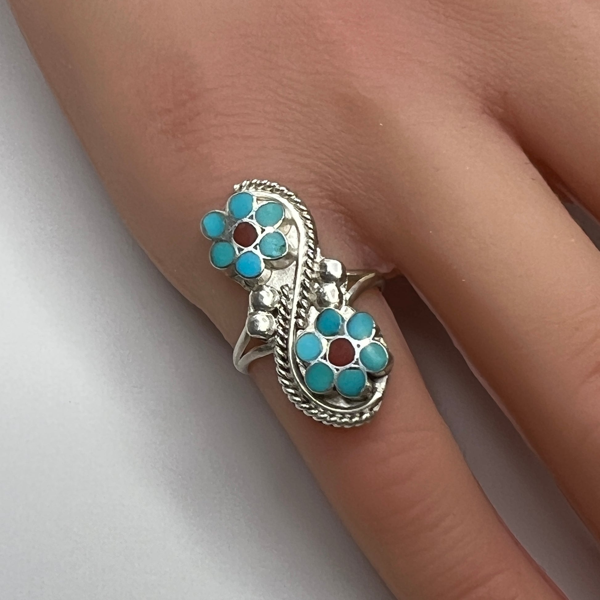 Sterling silver turquoise flower ring on hand, pinky fit with double floral design