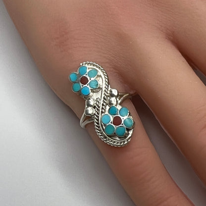 Sterling silver turquoise flower ring on hand, pinky fit with double floral design