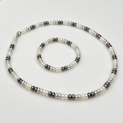 Close-up of matching pearl necklace and stretch bracelet in modern neutral tones
