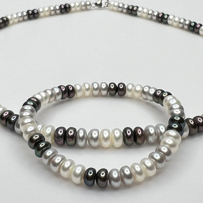 Close-up of matching pearl necklace and stretch bracelet in modern neutral tones