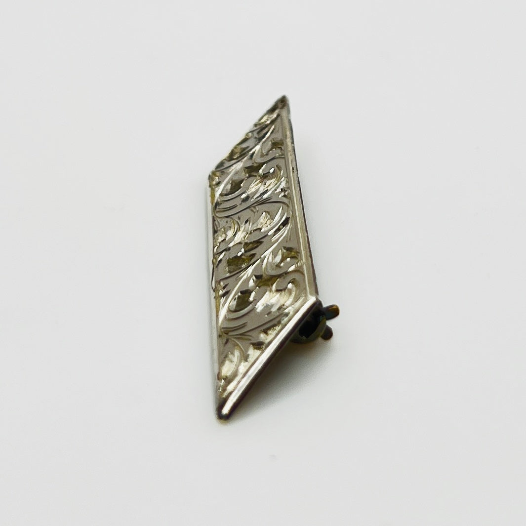 Close-up of engraved sterling silver bar brooch