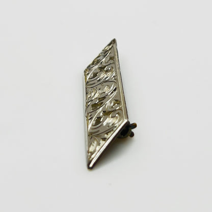 Close-up of engraved sterling silver bar brooch