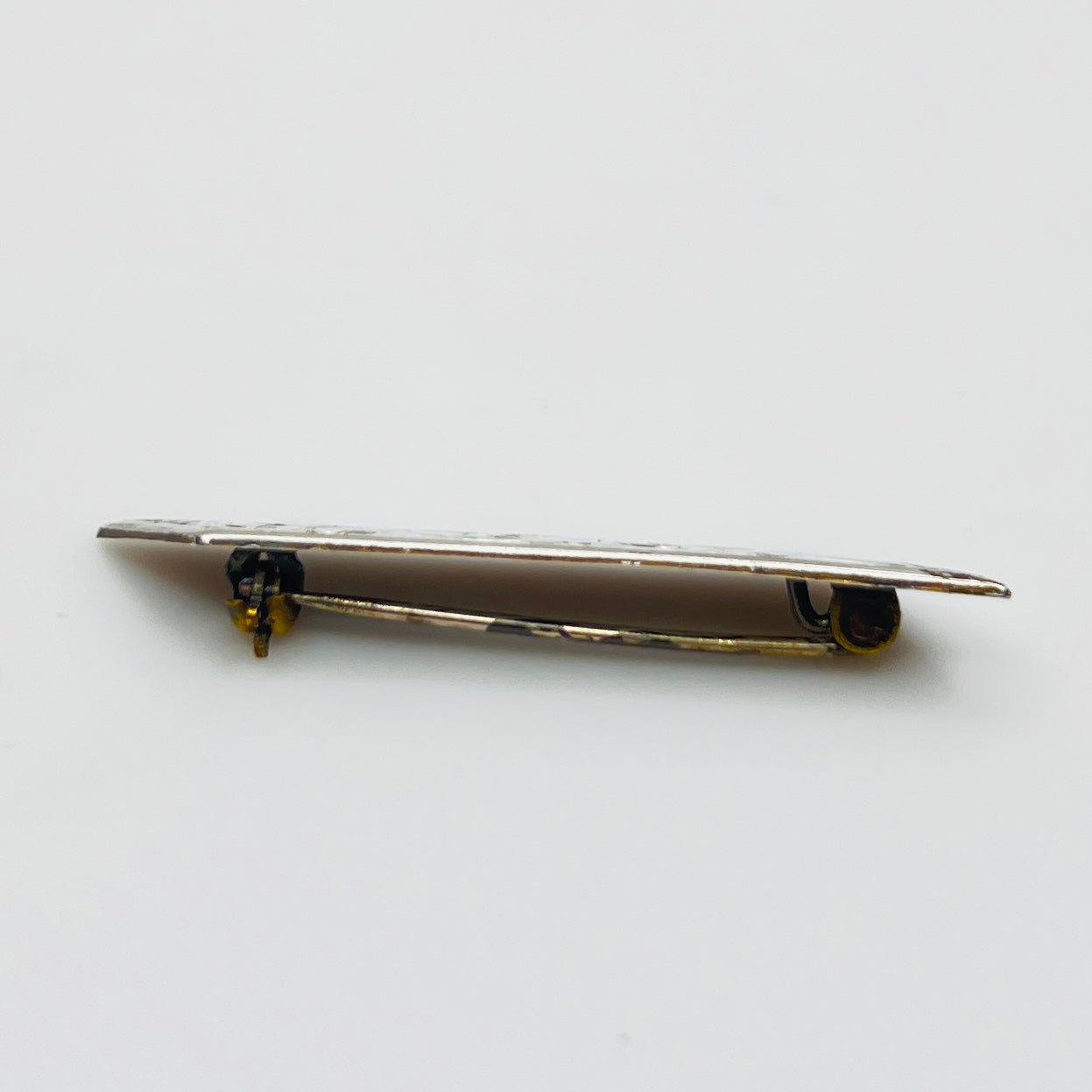 Close-up of engraved sterling silver bar brooch