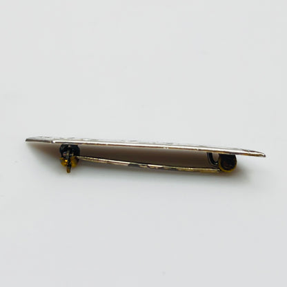 Close-up of engraved sterling silver bar brooch
