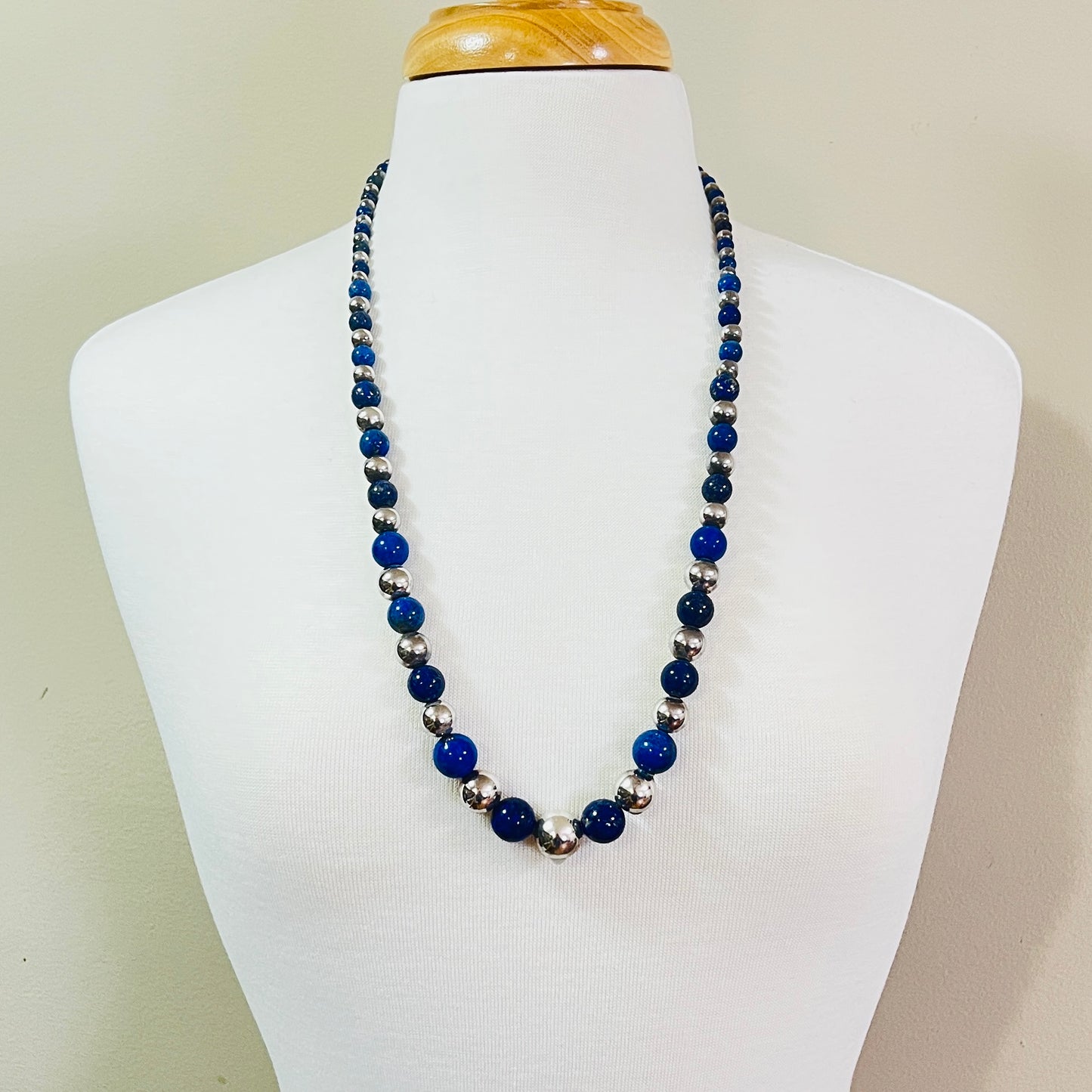 Vintage lapis and sterling bead necklace displayed on jewelry bust