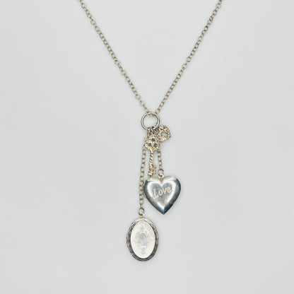 Sterling silver charm necklace with heart and oval lockets