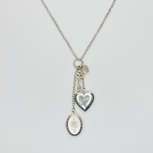 Sterling silver charm necklace with heart and oval lockets