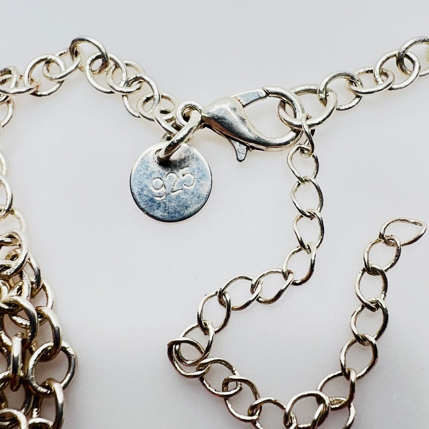 Sterling silver charm necklace with heart and oval lockets