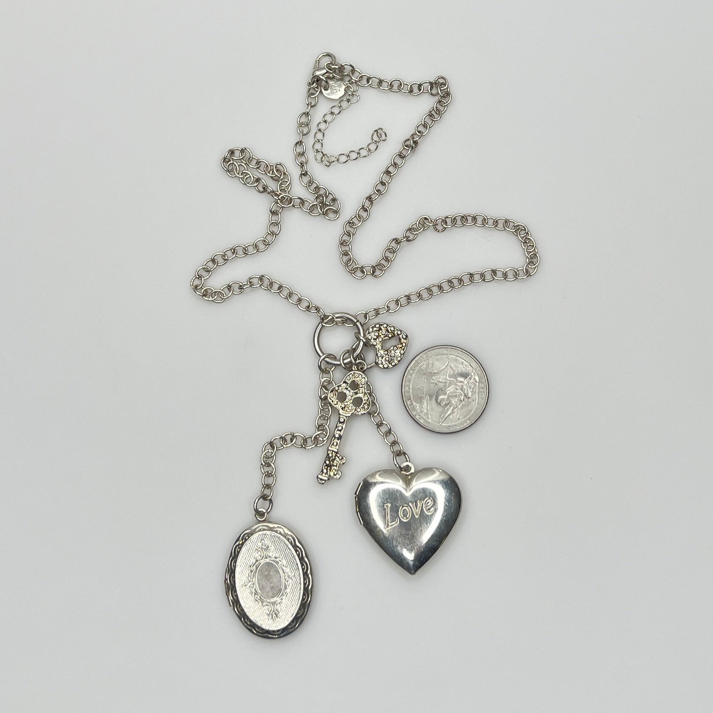 Sterling silver charm necklace with heart and oval lockets