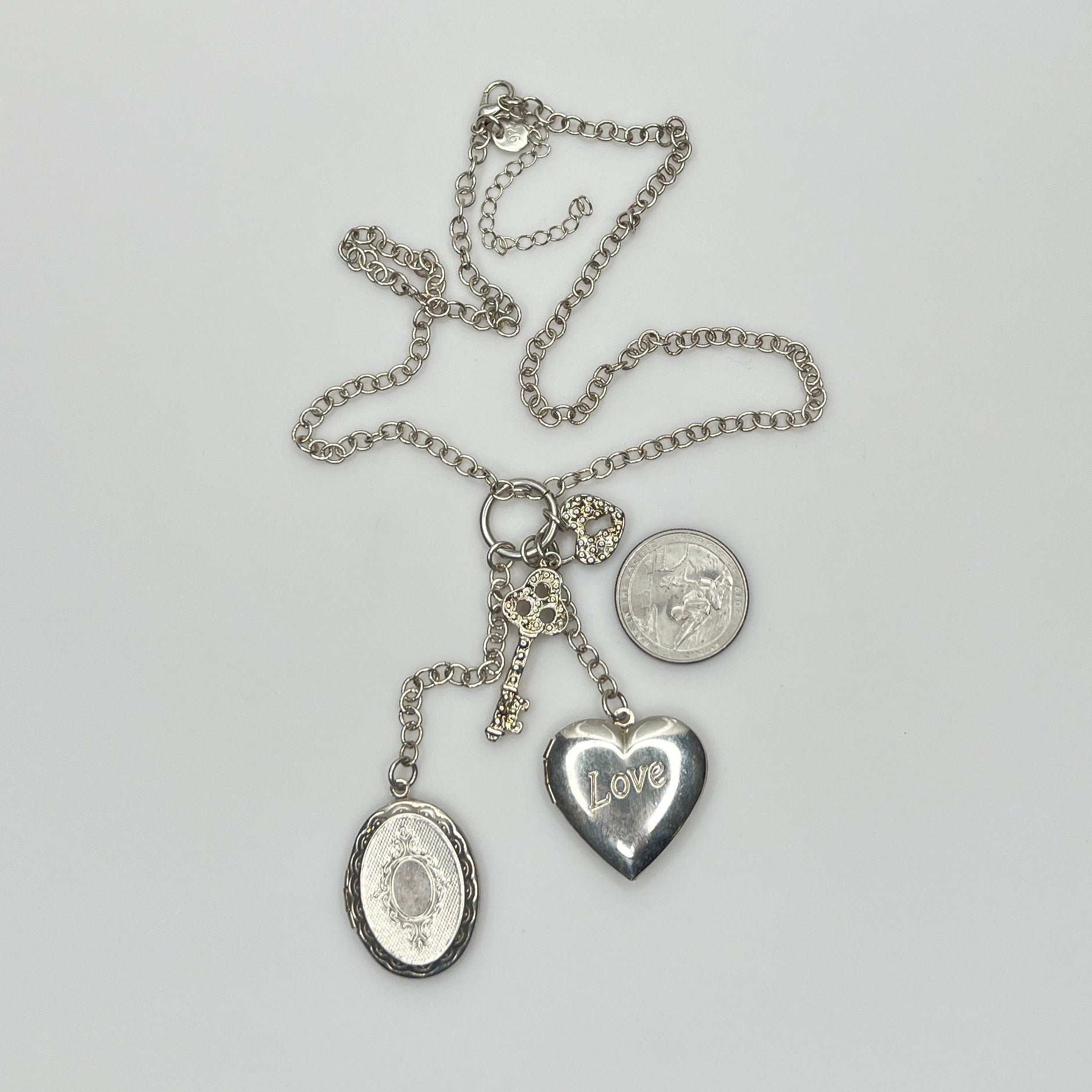 Sterling silver charm necklace with heart and oval lockets