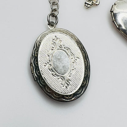 Ornate oval sterling silver locket charm detail