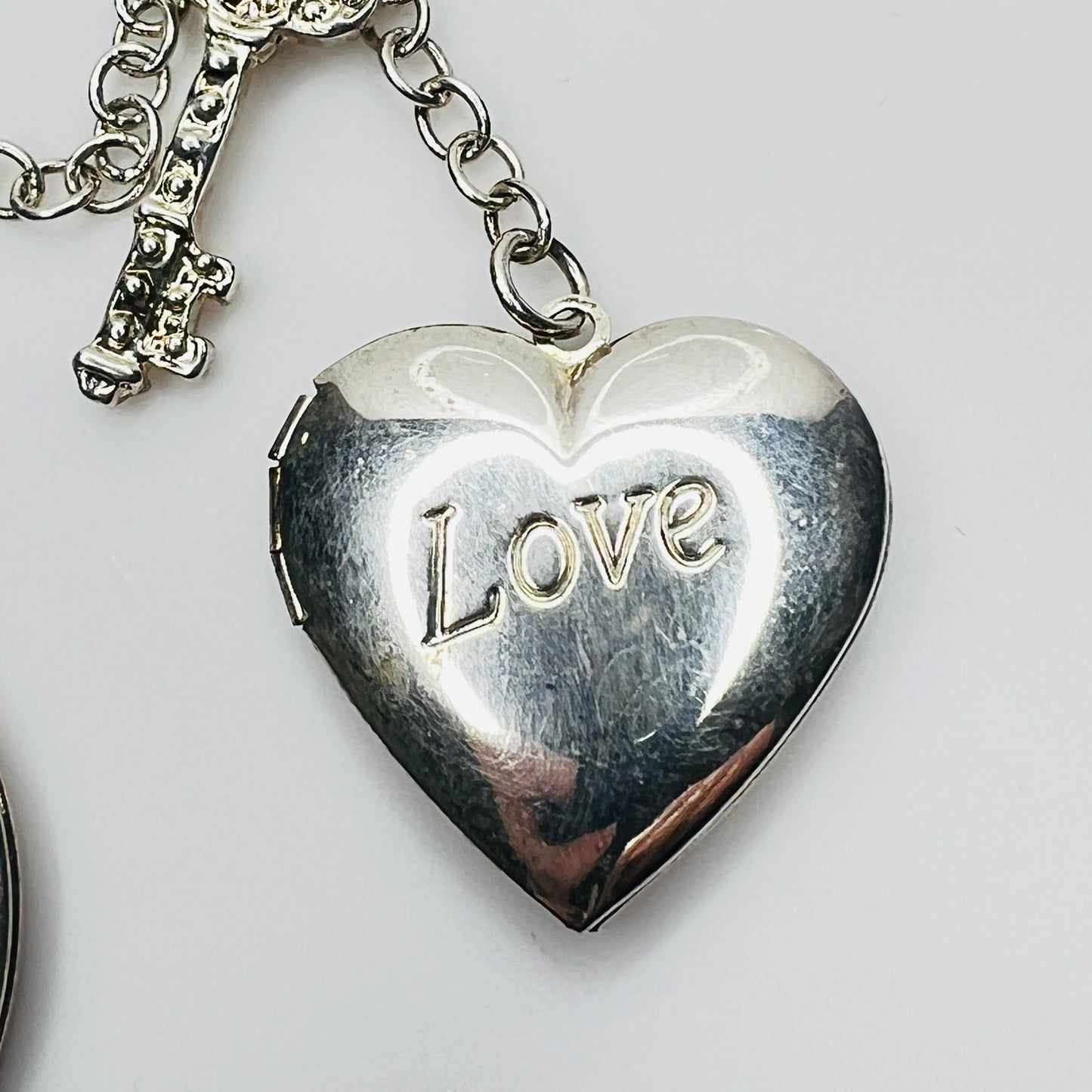 Close-up of heart locket engraved Love in sterling silver