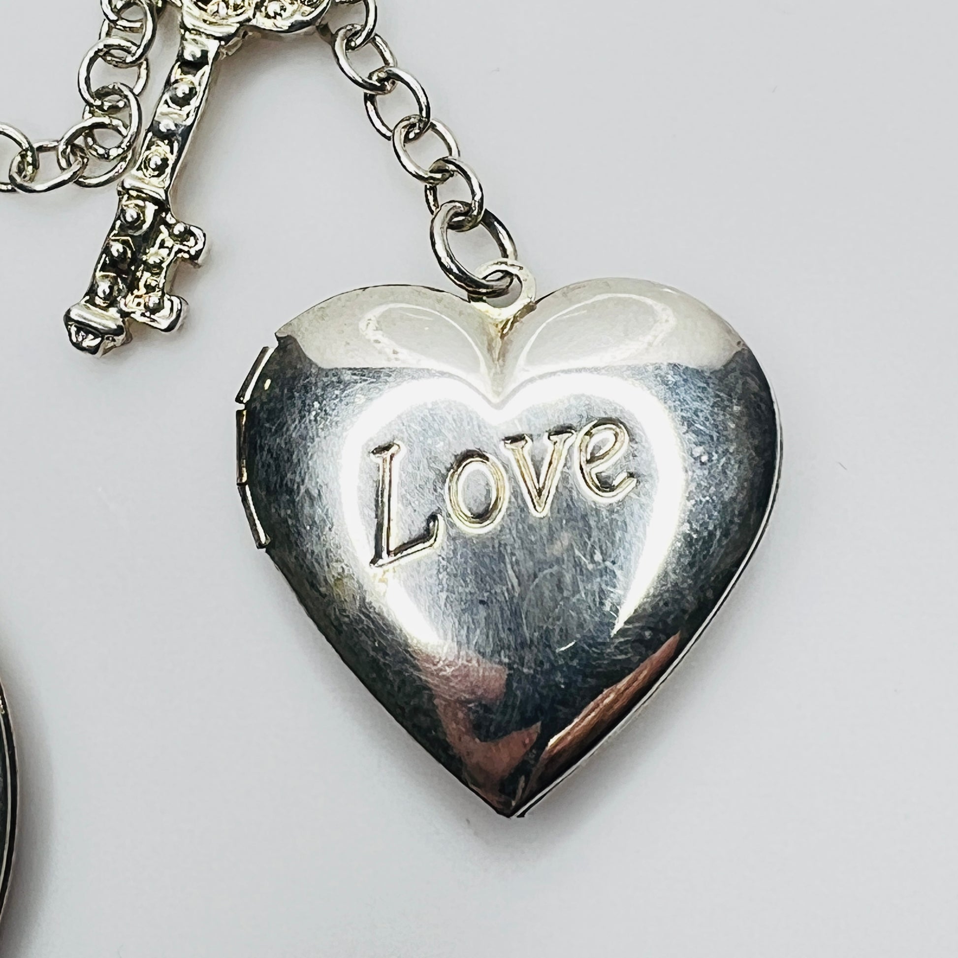 Close-up of heart locket engraved Love in sterling silver