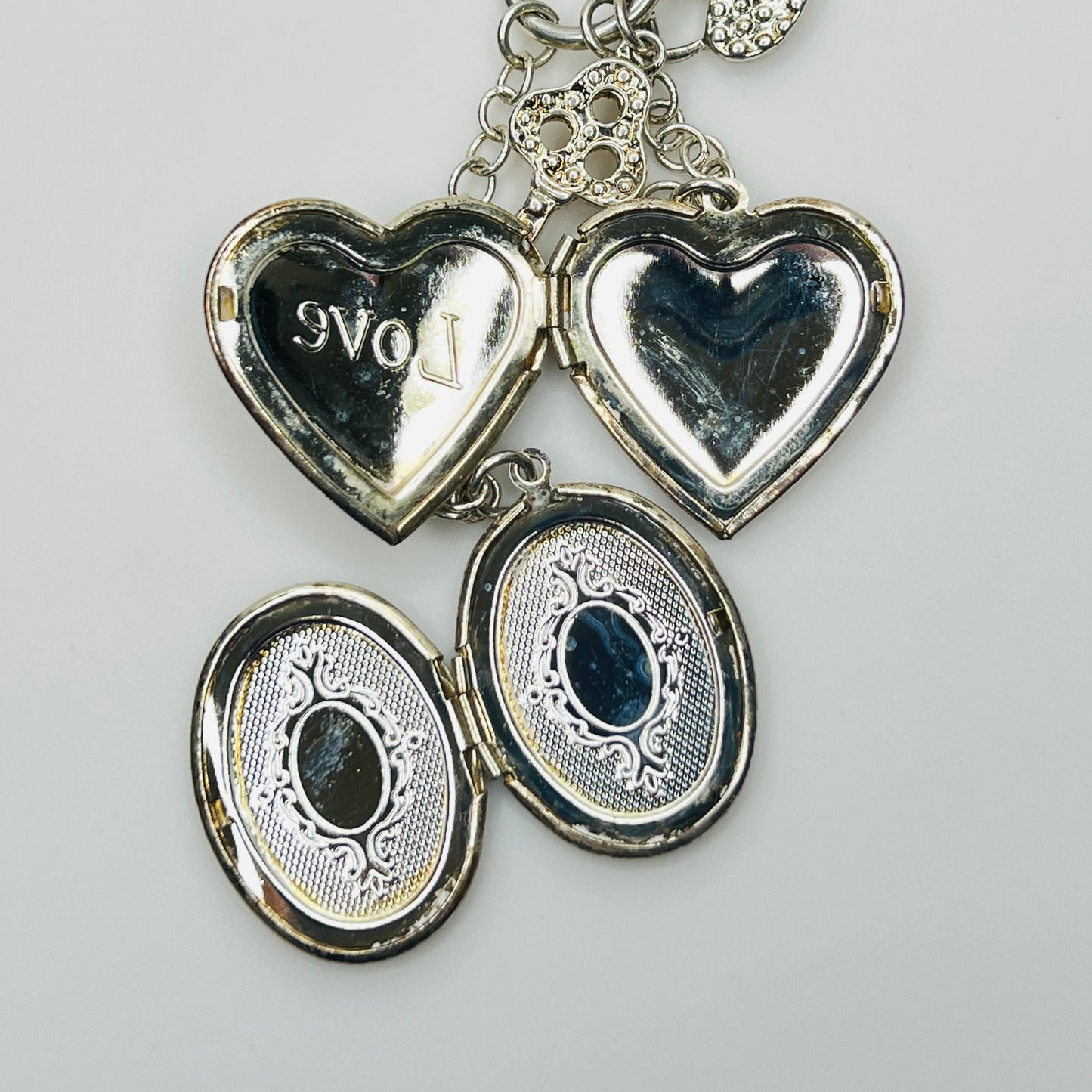 Sterling silver charm necklace with heart and oval lockets