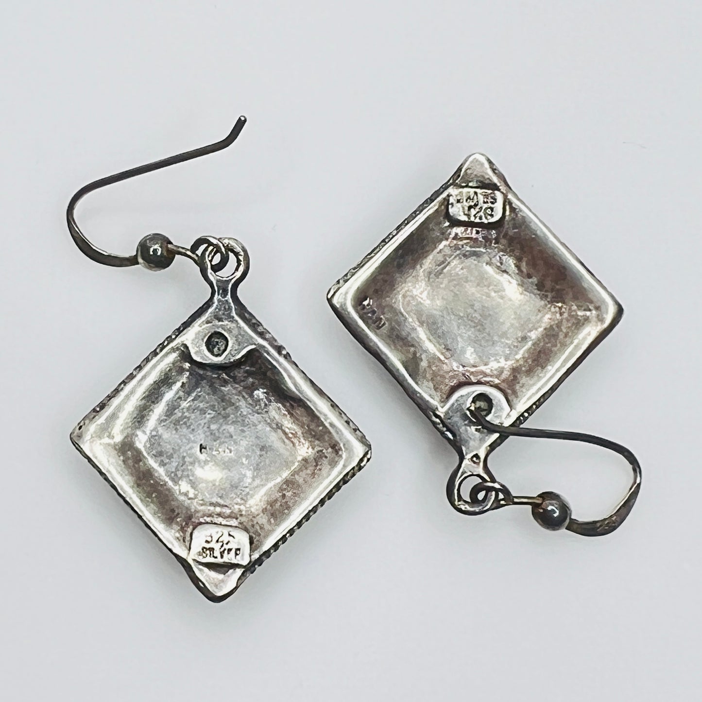 Back of 925 sterling silver artisan dangle earrings