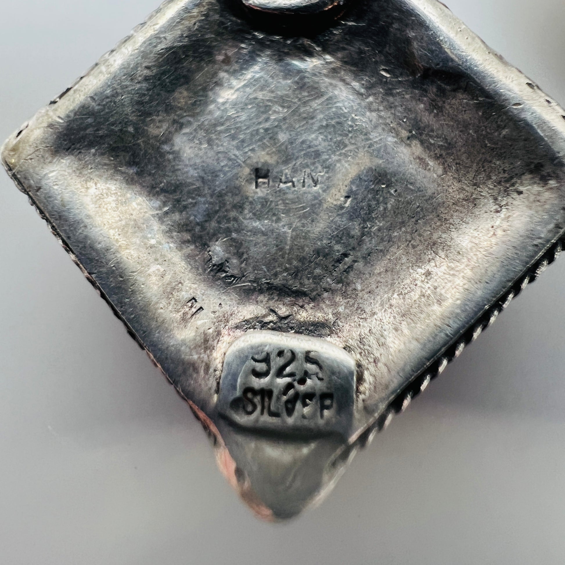 Back of 925 sterling silver artisan dangle earrings