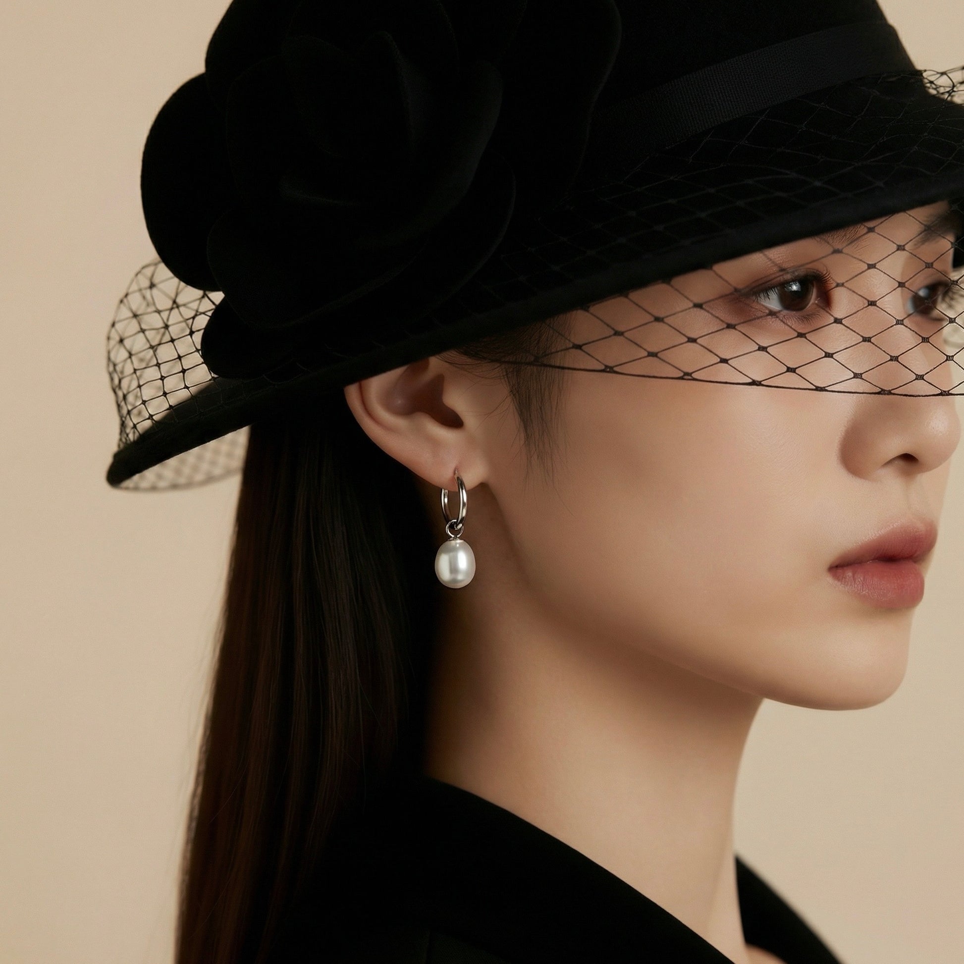 Model wearing sterling pearl hoop earrings